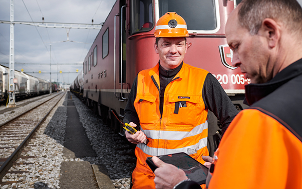 Deux conseillers à la sécurité contrôlent un train.